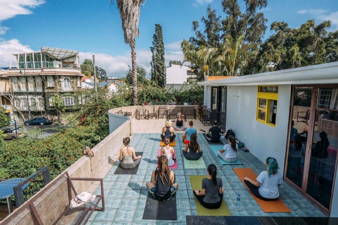 Hacer yoga en la terraza de la azotea en Selina San José